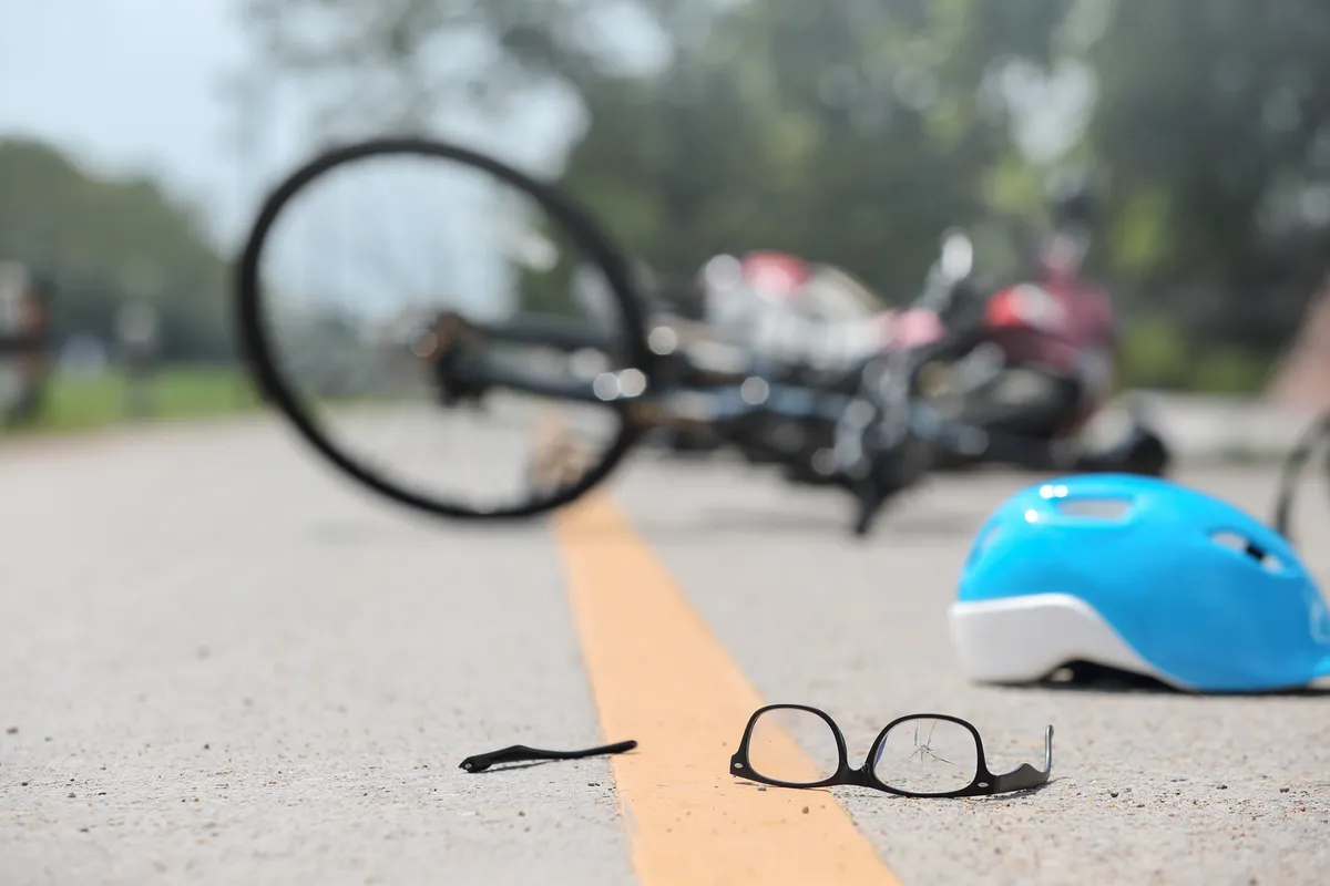 An image of a cyclist riding on the road represents the risk of a bike accident