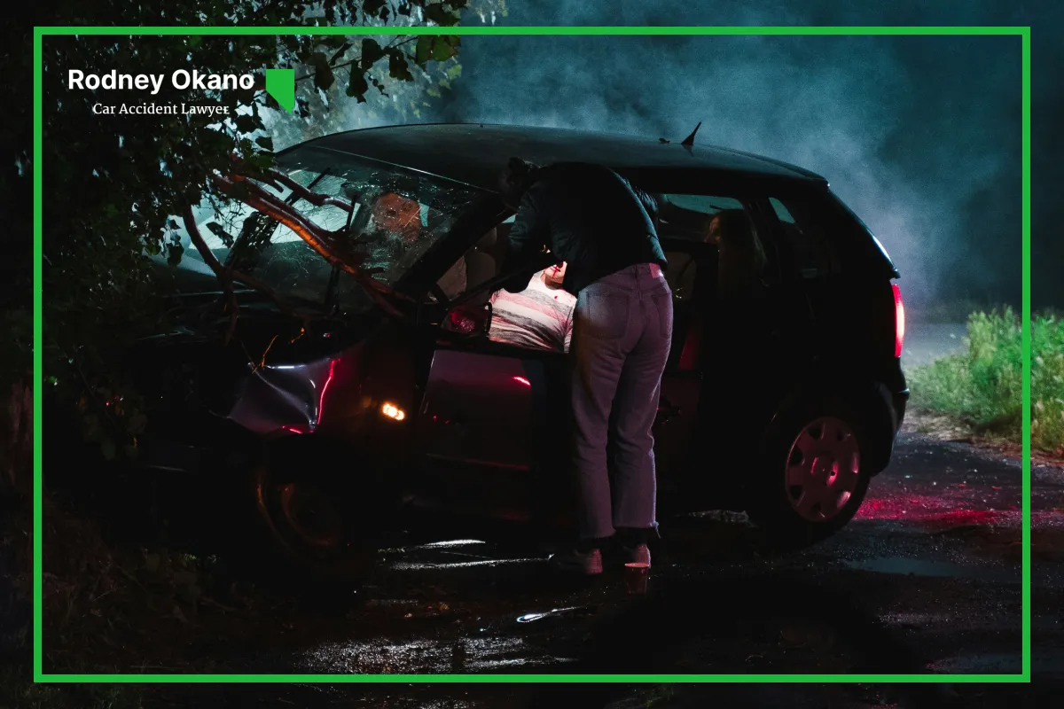 Image of a car that crashed into a tree at night on the road