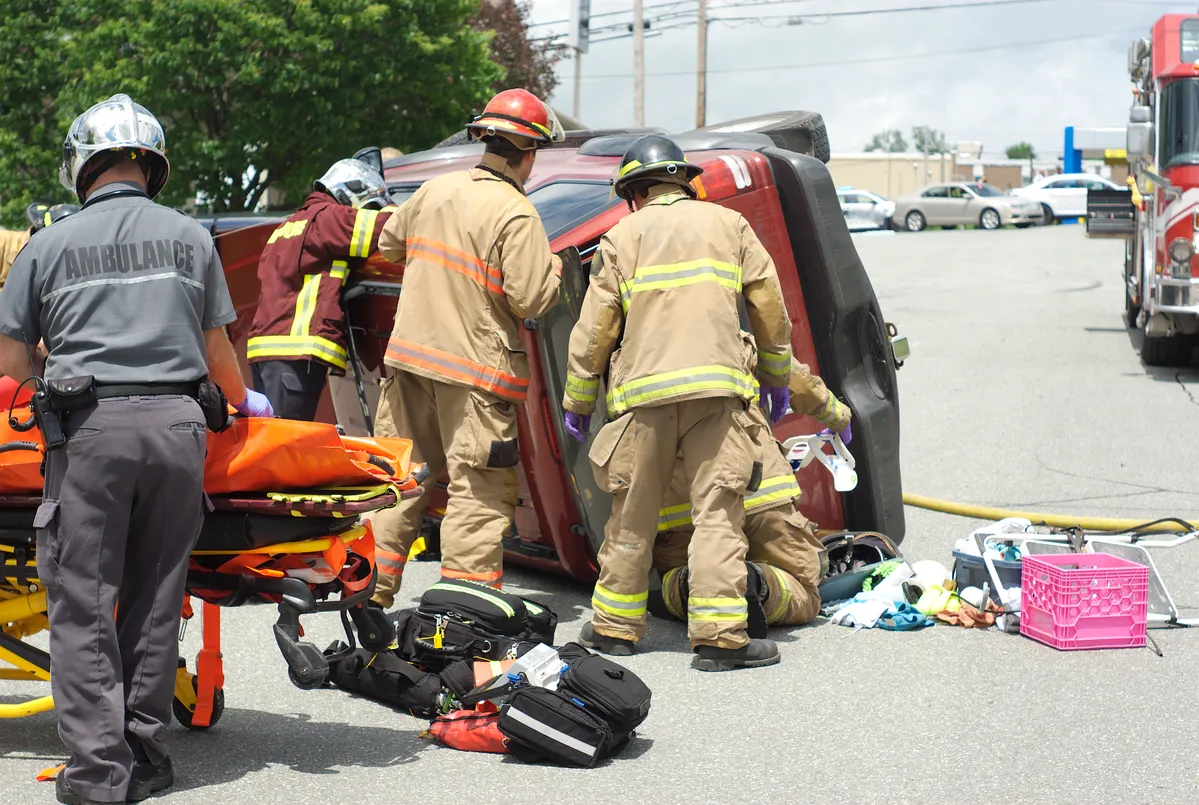 Image of paramedics and firefighters responding to a car accident to represent the steps to take after one