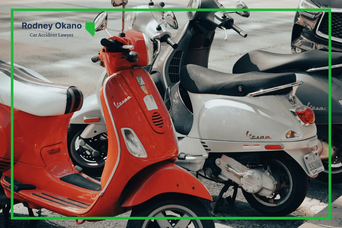 Image of three mopeds parked on the side of the road.