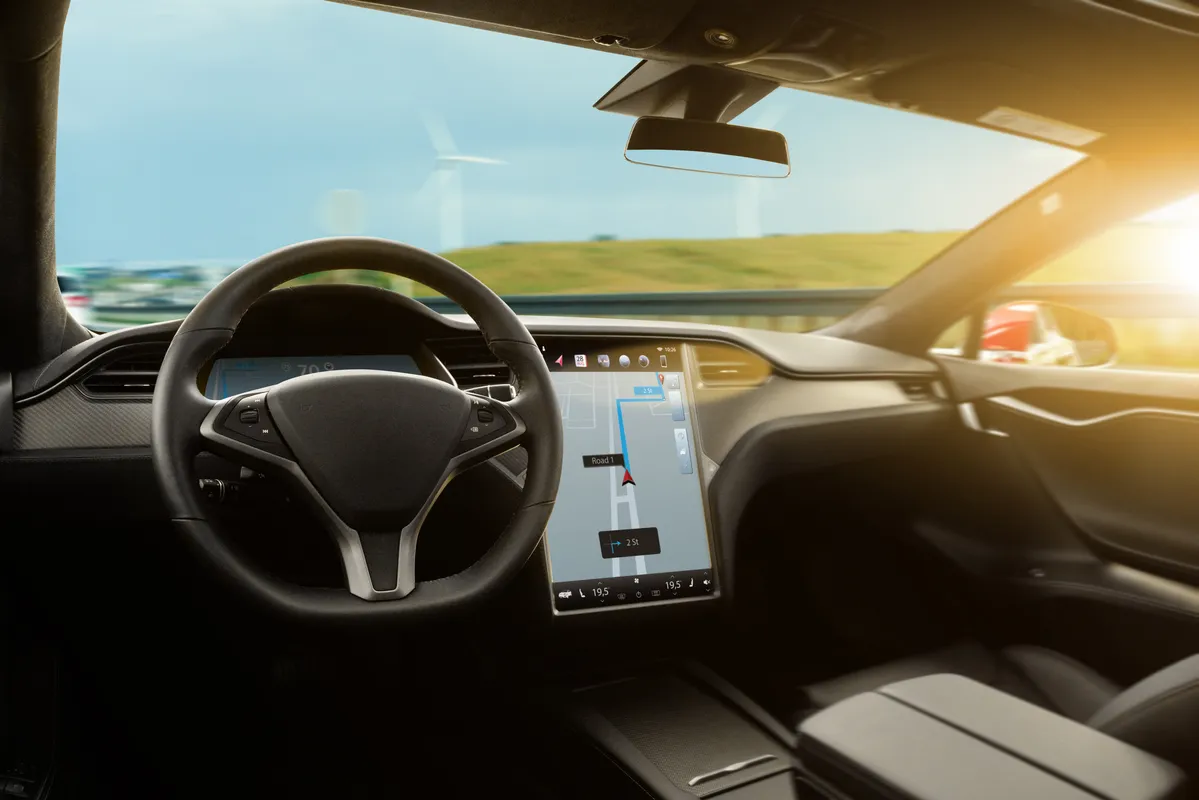 a close up of a car dashboard with a steering wheel and a display