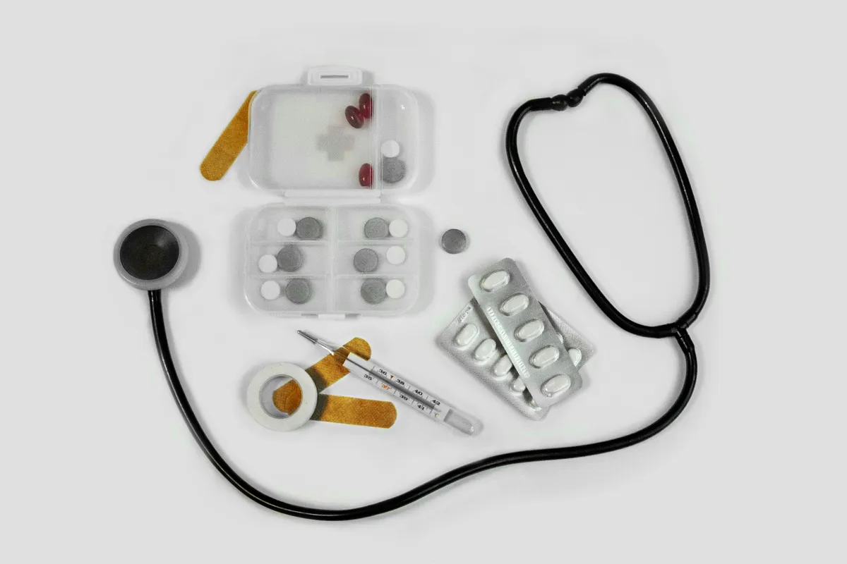a close up of a stethoscope, pills, and a syll