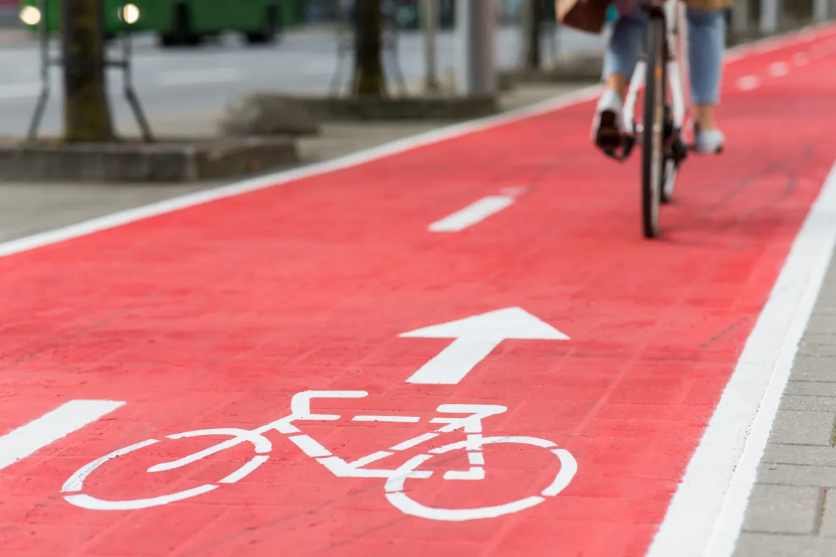  a person riding a bike on a red bike lane