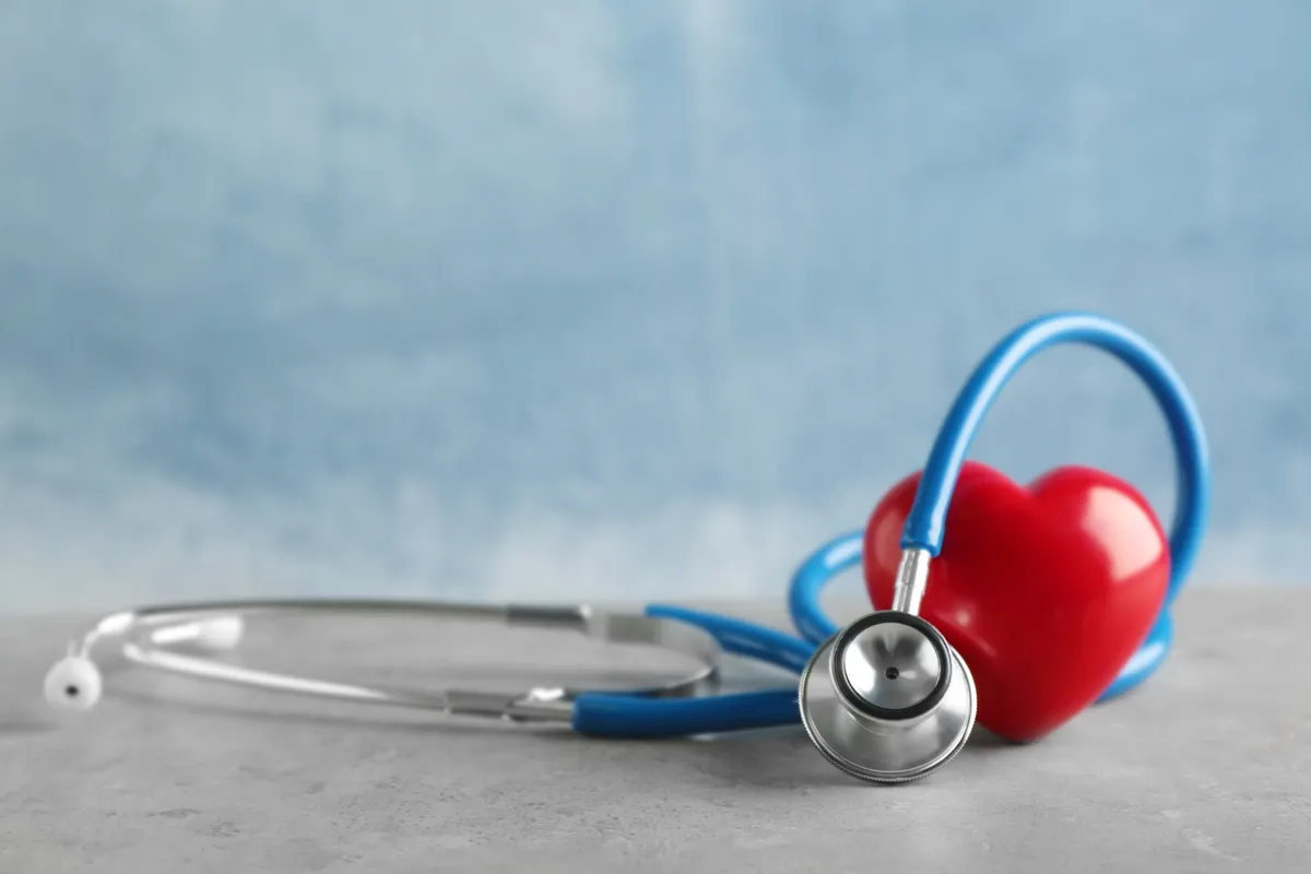  a red heart and a stethoscope on a table
