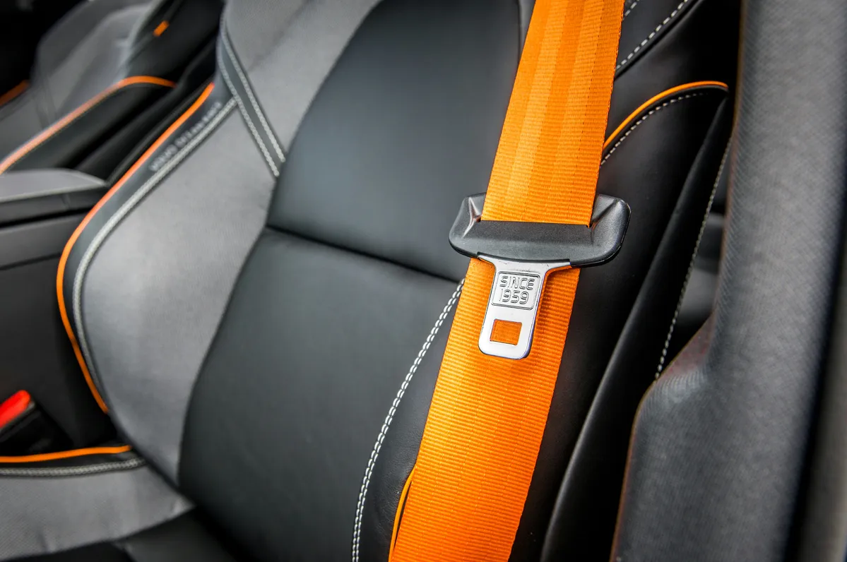  a seat belt that is attached to the back of a car