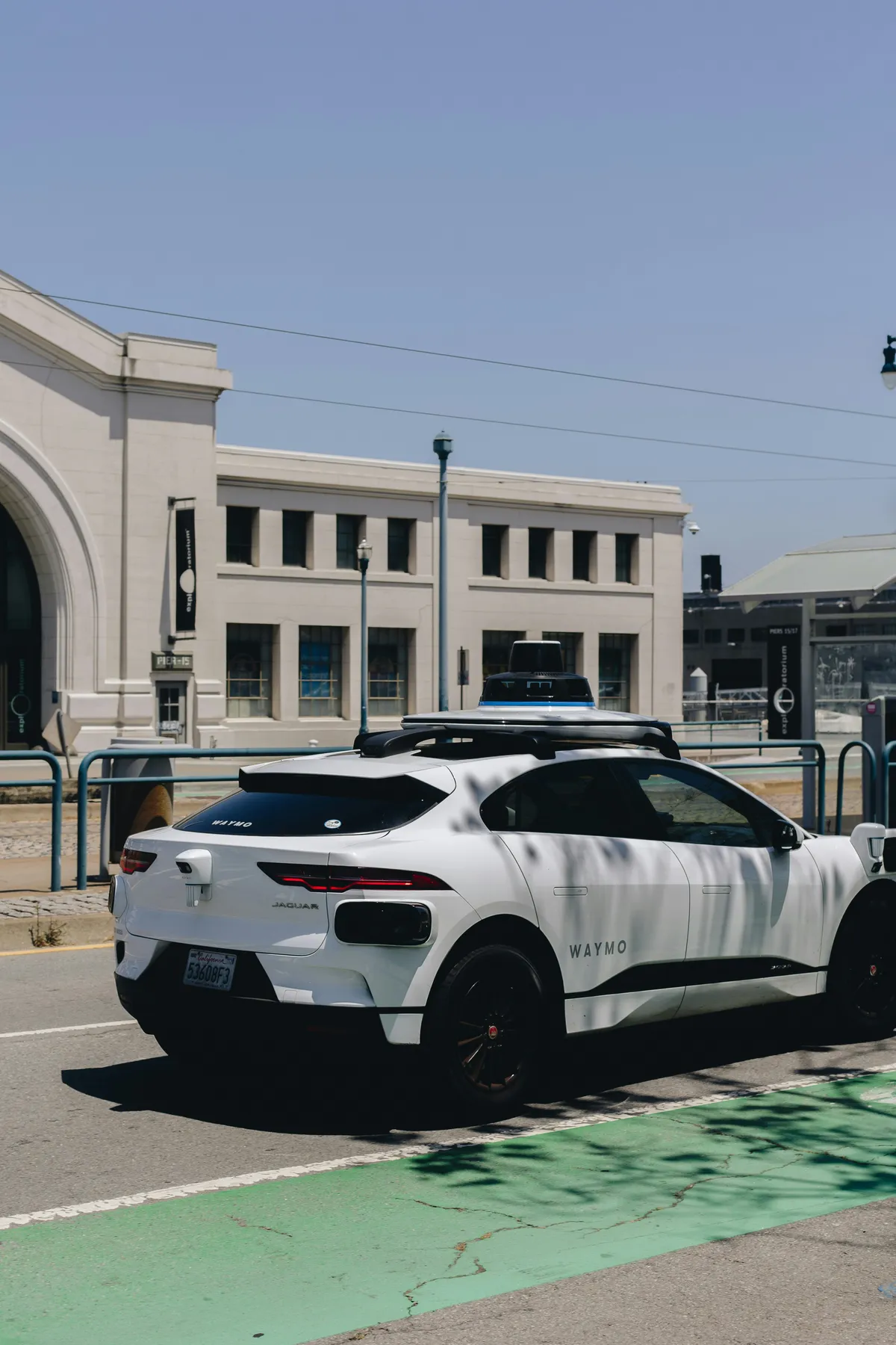 a white car parked in a parking lot next to a building