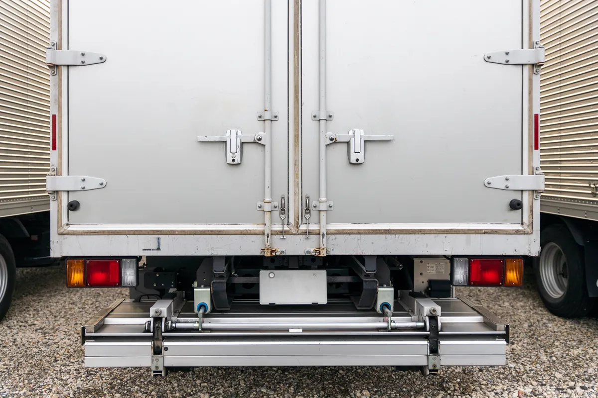  a white truck with a trailer attached to it