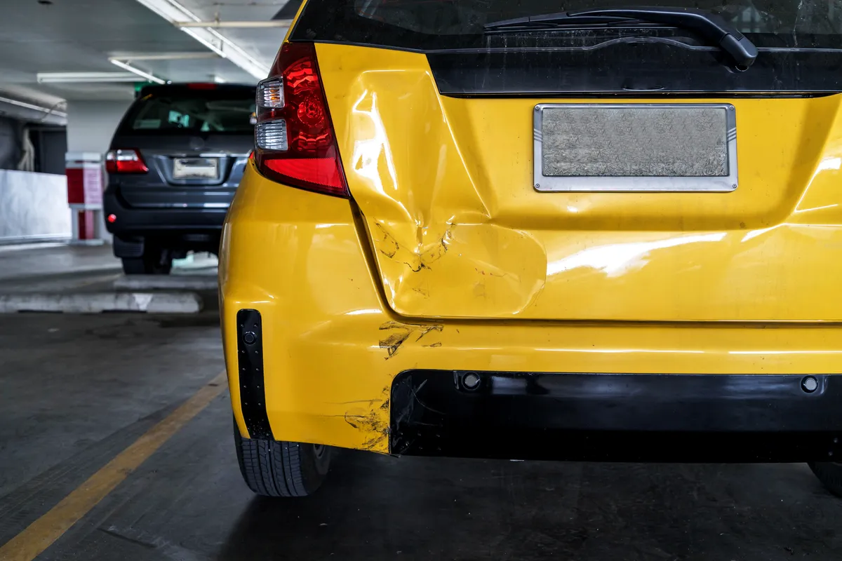  a yellow car parked in a parking garage