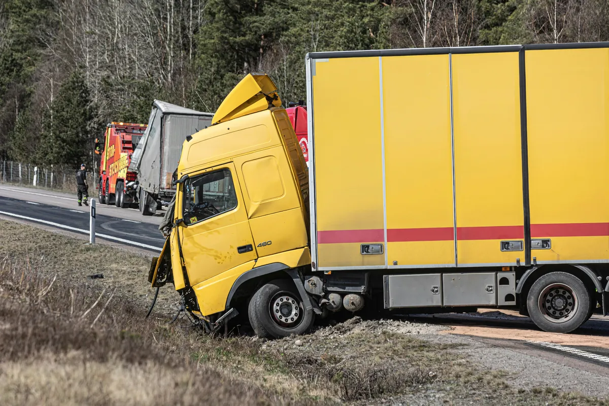 a yellow truck that has crashed into the side of the road