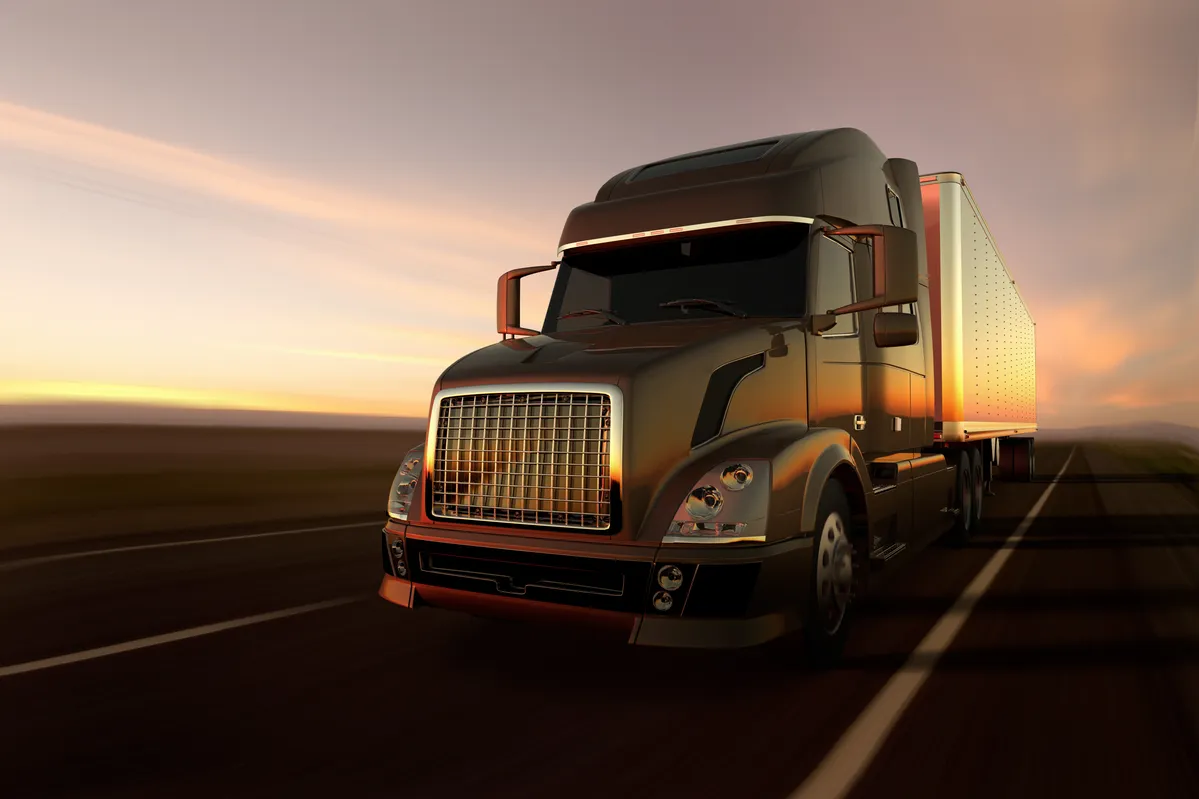 araf truck driving on a highway at sunset with a sky background