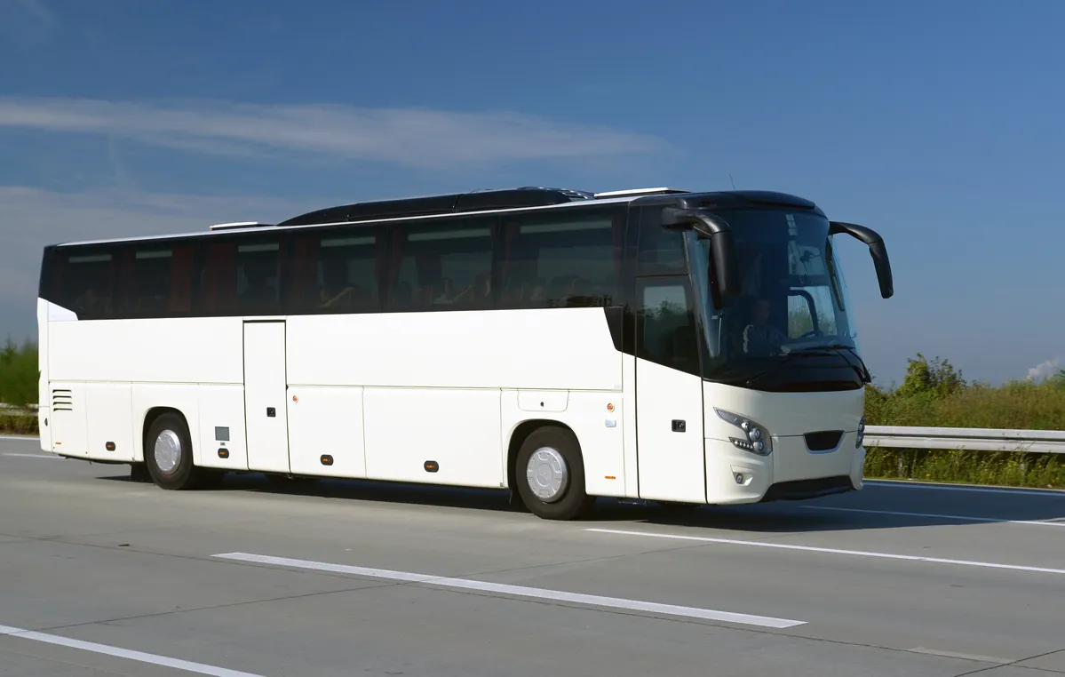 arafed bus on the road with a sky background
