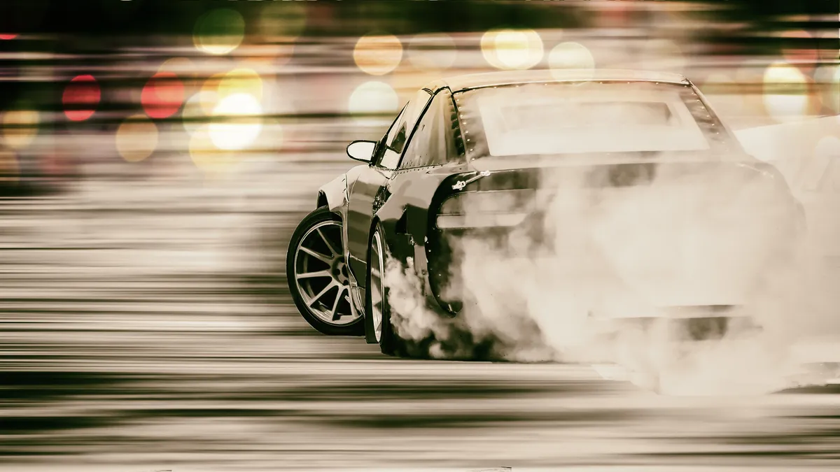 arafed car with smoke coming out of it ' s exhaust pipes