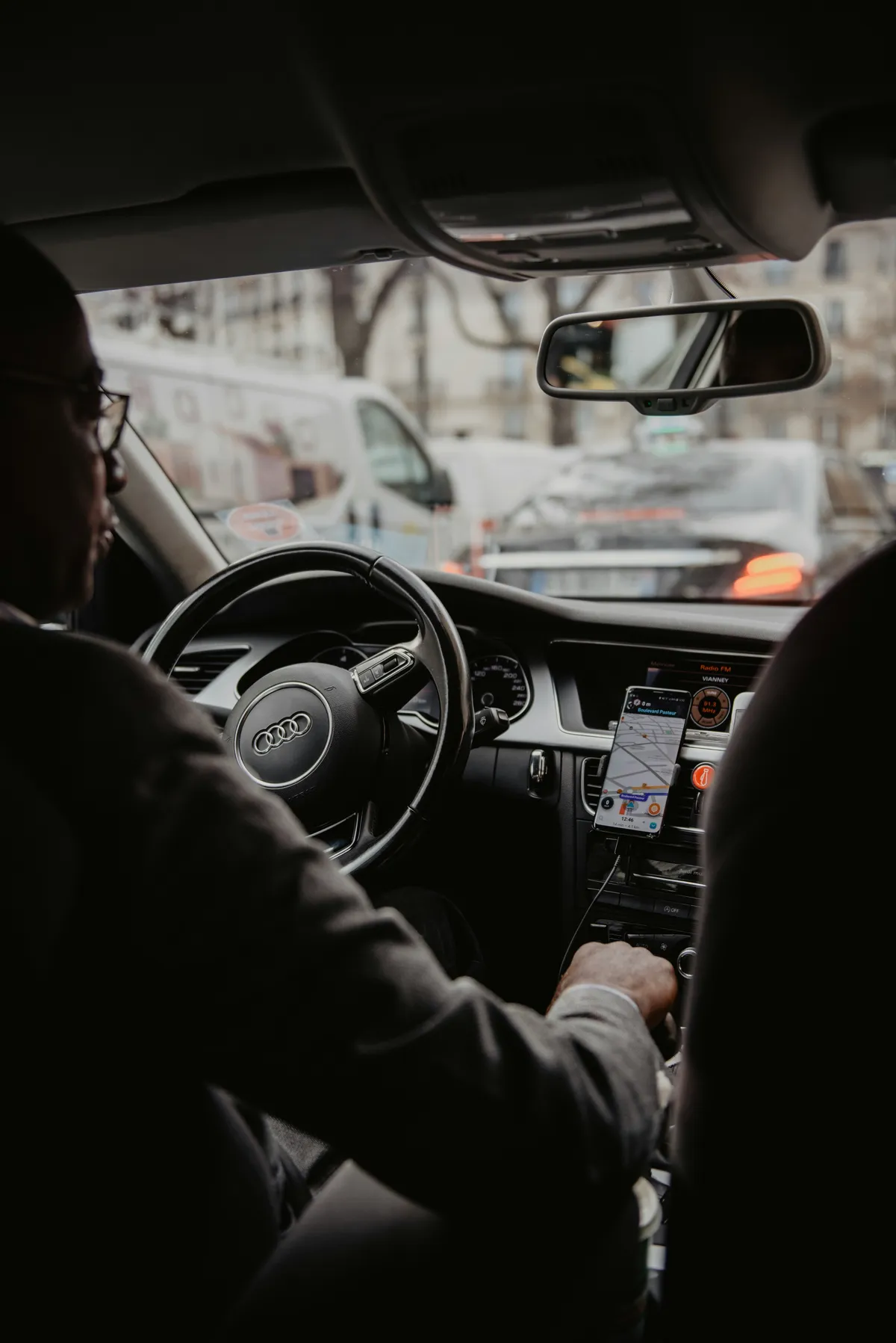 arafed man in a car with a cell phone in his hand