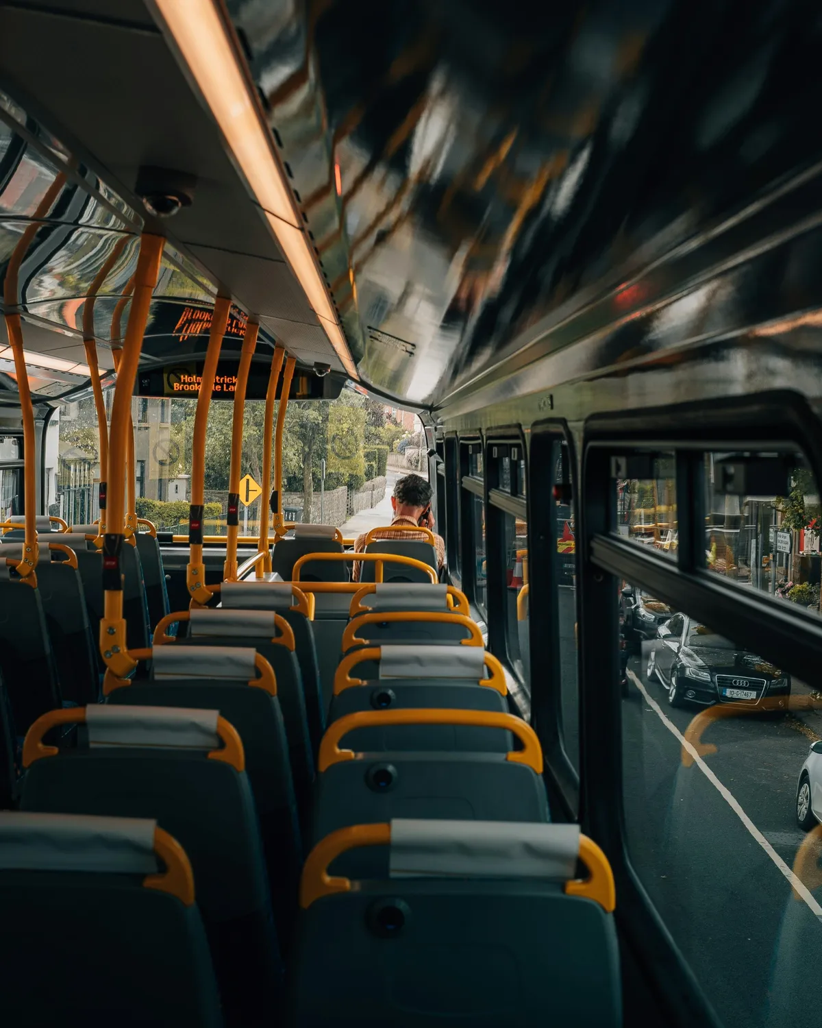 arafed view of a bus with rows of seats and a man sitting on the front
