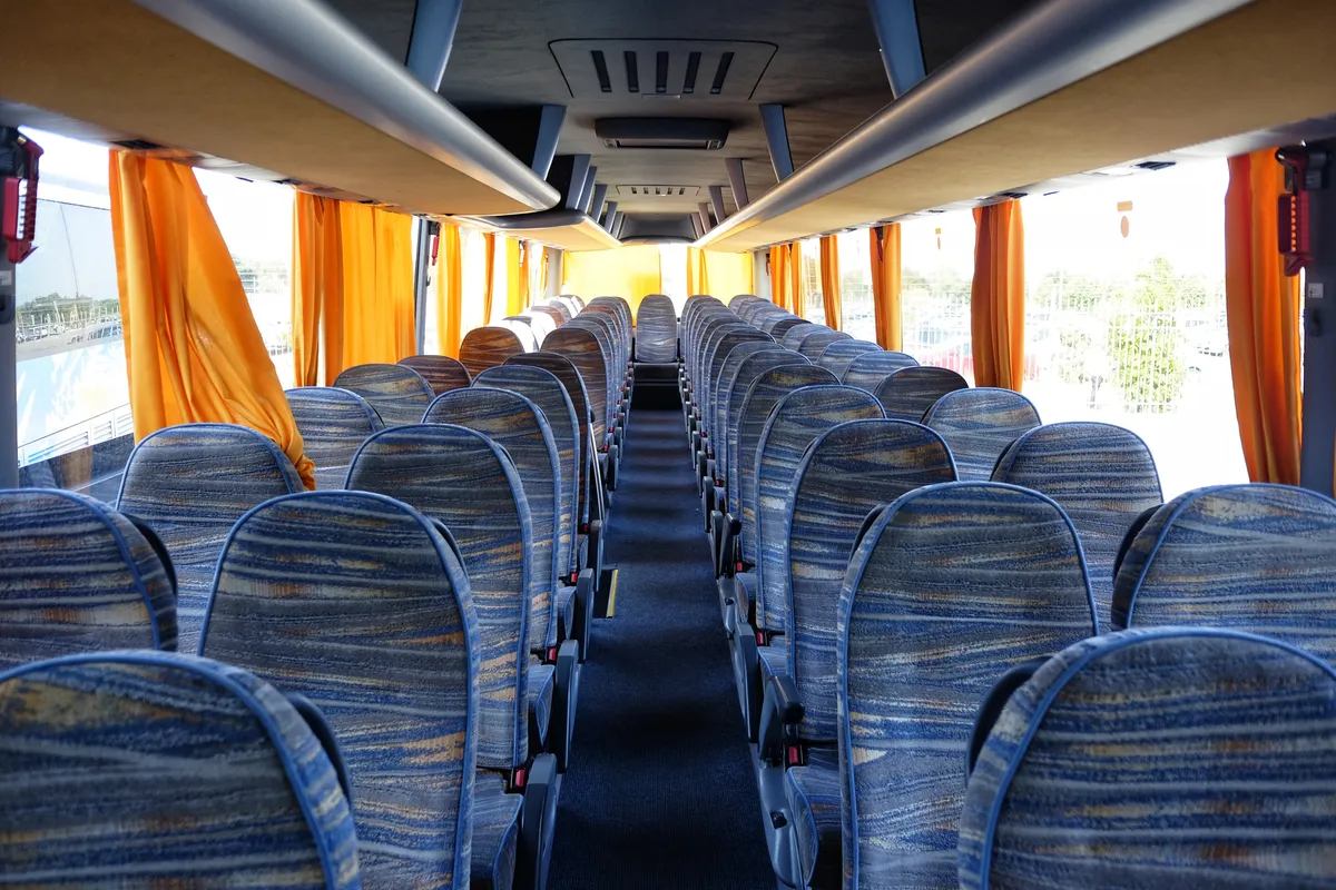 arafed view of a bus with rows of seats and orange curtains
