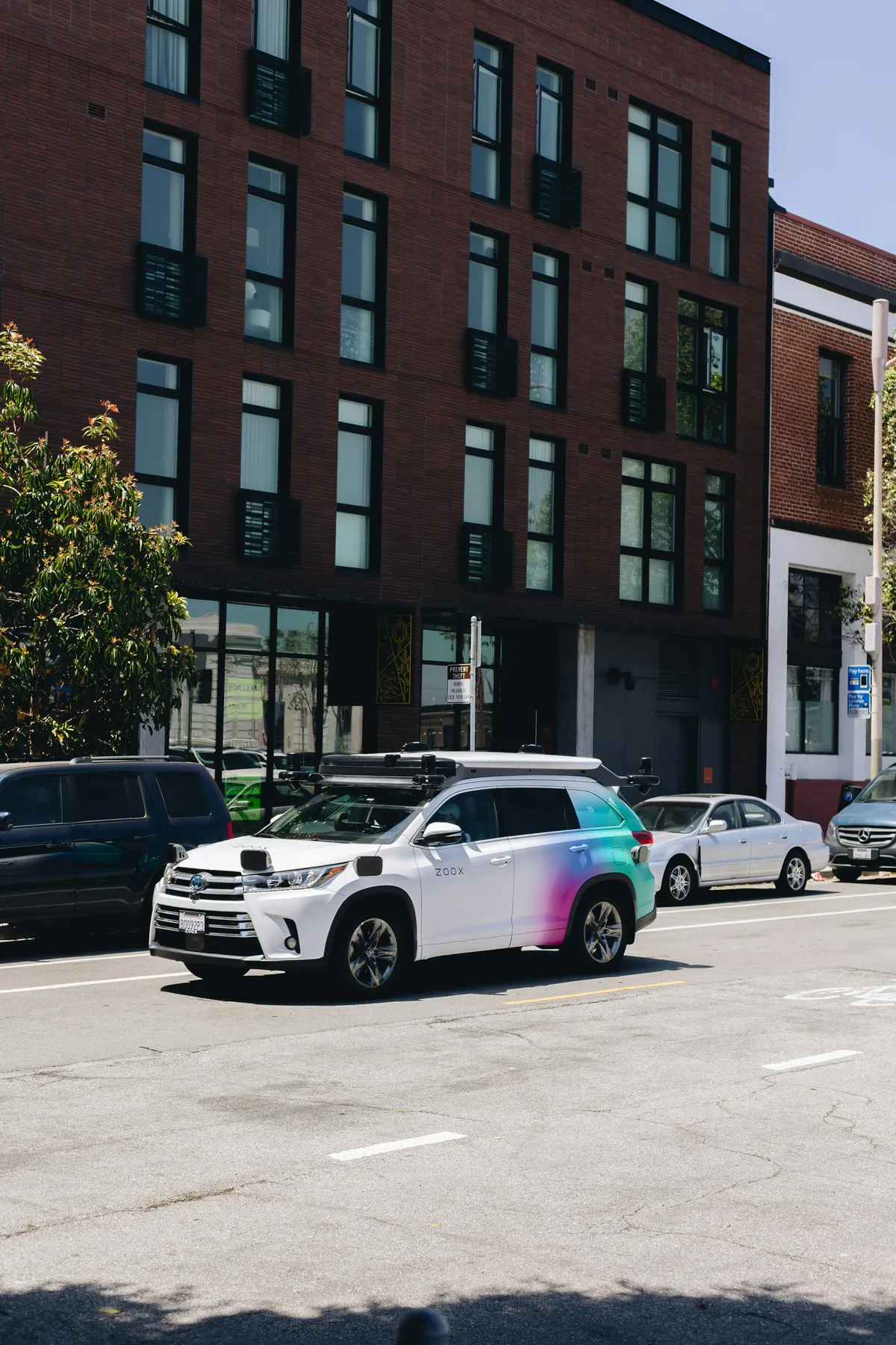 cars parked on the side of the road in front of a building