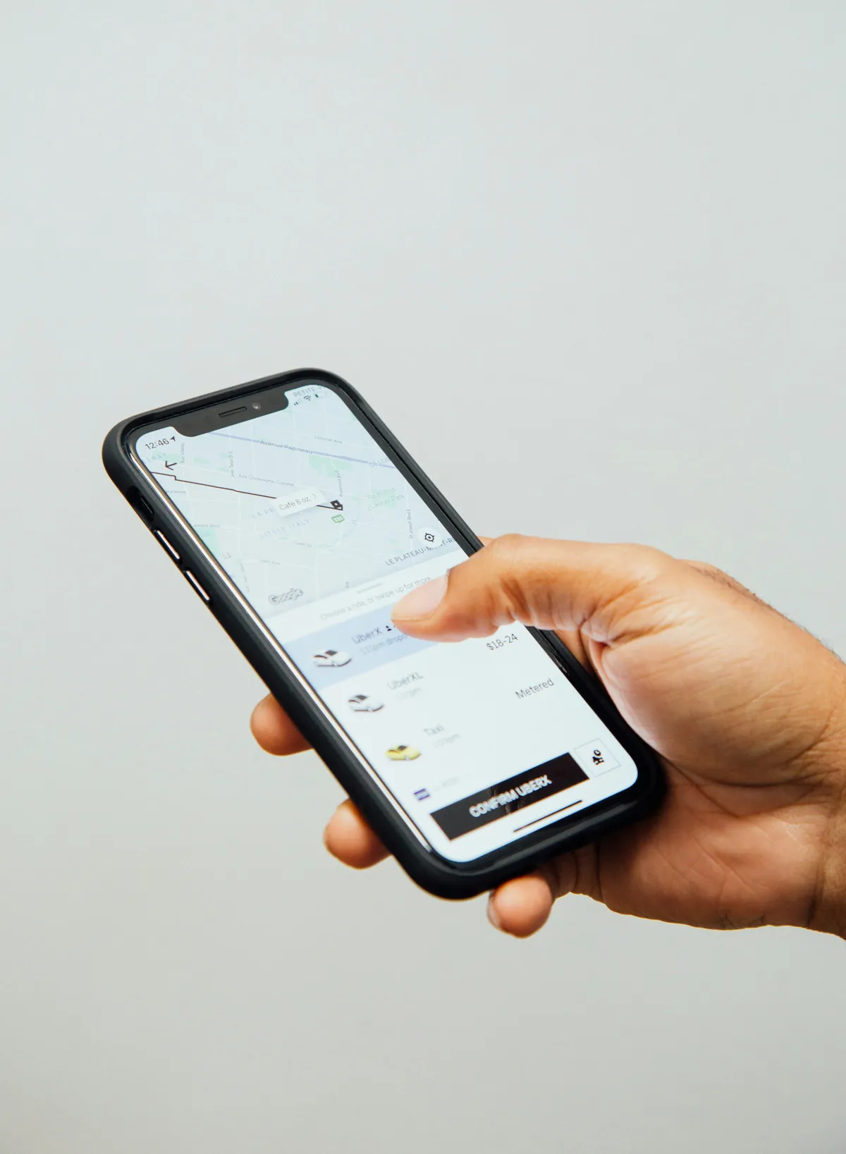someone holding a cell phone with a map on the screen