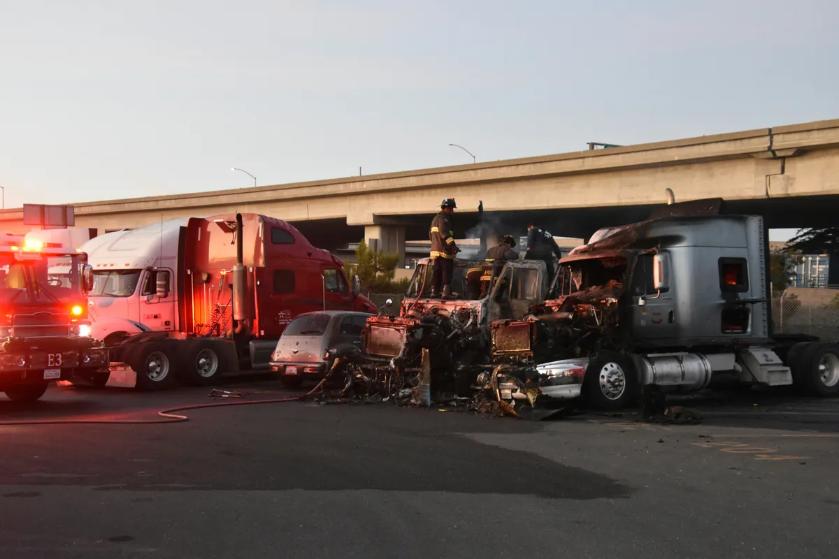 two trucks that are parked in a lot